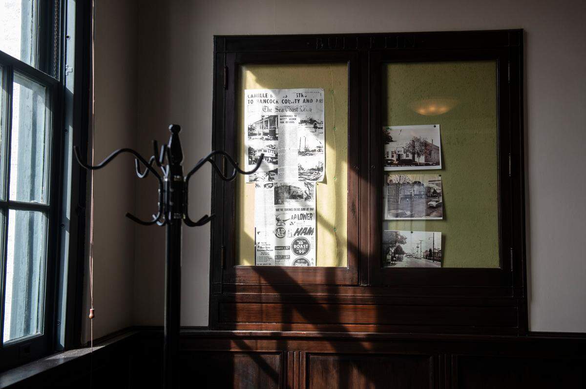 Preserved news clippings and photographs line the walls at Fairly Local, a new menswear shop in the old post office building in Bay St. Louis on Thursday, Dec. 7, 2023. The shop, which is the second in a small chain, will have an in-store barber shop, coffee shop, humidor for cigars and a variety of menswear brands.