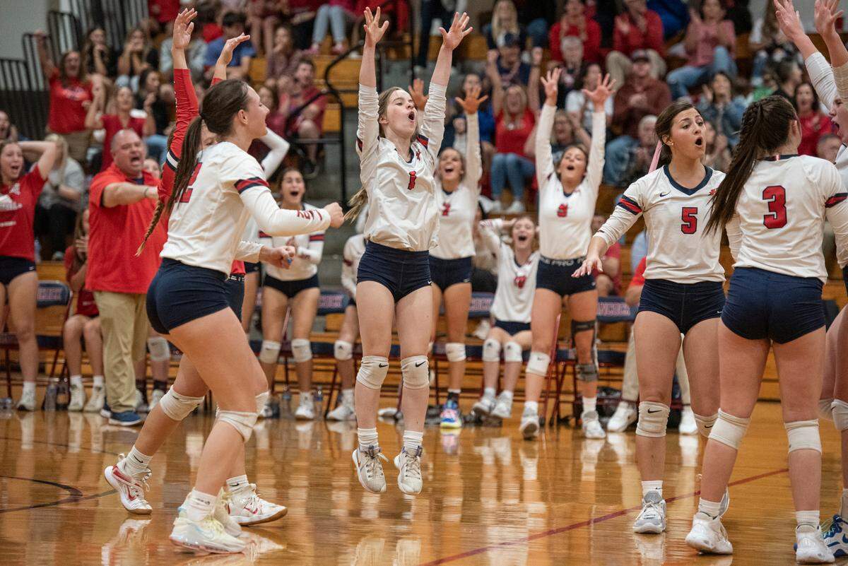 The Hancock Hawks volleyball team celebrates after a point during the 6A South State Championship game at Hancock High School in Kiln on Monday, Oct. 16, 2023.