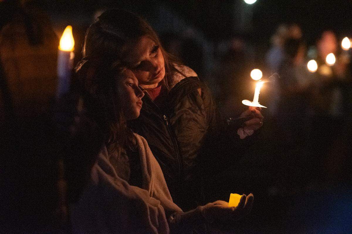 Community members hold candles in honor of fallen officers during a candlelit vigil for Bay St. Louis Sgt. Steven Robin and officer Branden Estorffe at Tiger Stadium in Bay St. Louis on Thursday, Dec. 15, 2022. Robin and Estorffe were killed on Wednesday when a woman shot both of them.