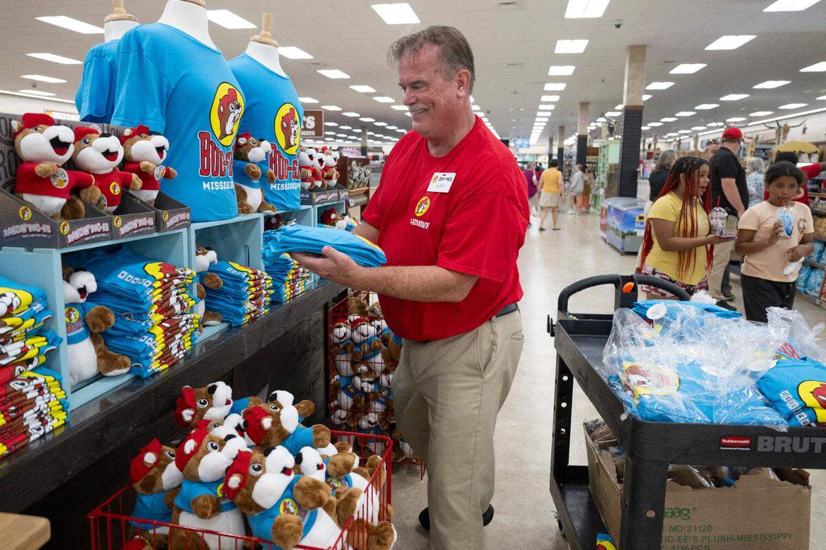 Workers restock Buc-ee’s merchandise during opening day of Buc-ee’s first Mississippi location in Harrison County on Monday, June 9, 2025.
