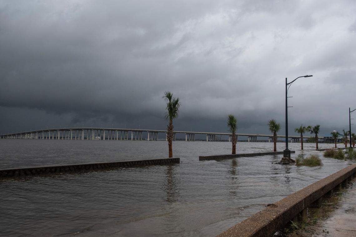 Palm trees on Front Beach in Ocean Springs are submerged by storm surge as Hurricane Ida arrives on Sunday.