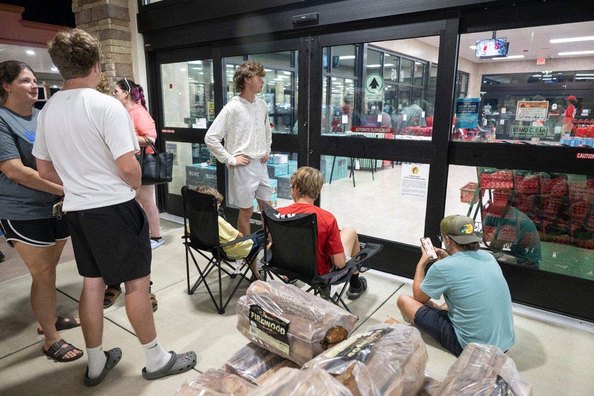 Fans of travel stop chain Buc-ee’s wait outside the newest location, located in Harrison County, MS, before the grand opening on Monday, June 9, 2025.