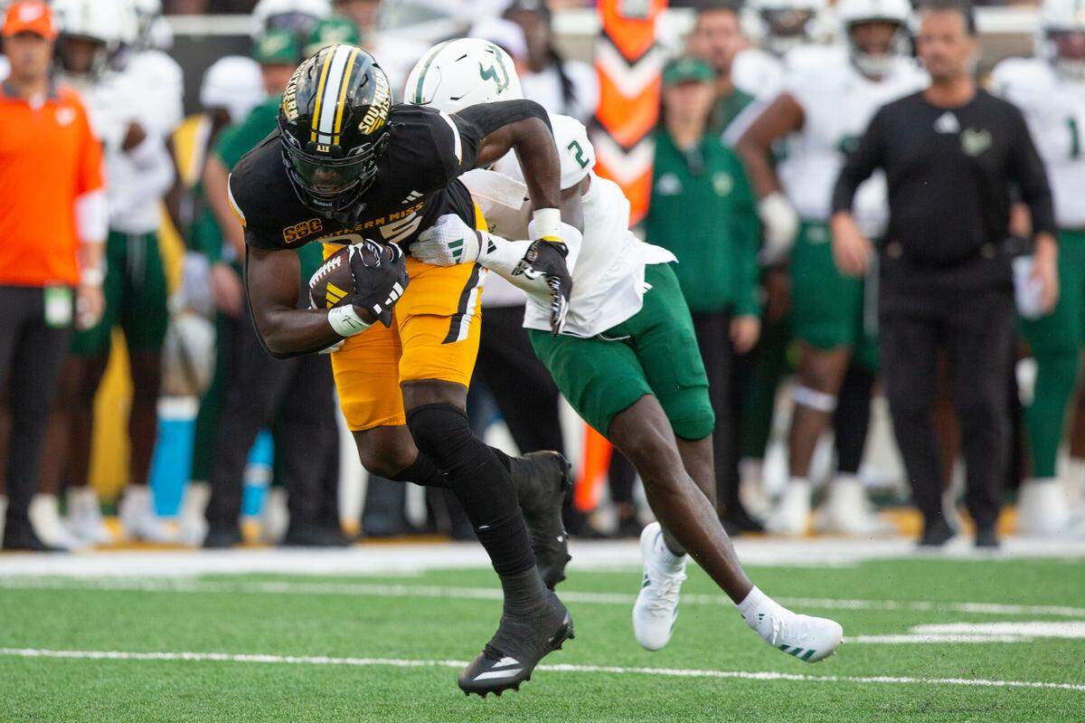 Southern Miss Golden Eagles tight end Kyirin Heath (85) gets tackled by South Florida Bulls defensive back Tavin Ward (2) during a game between Southern Miss and South Florida at M.M. Roberts Stadium in Hattiesburg on Saturday, Sept. 14, 2024.