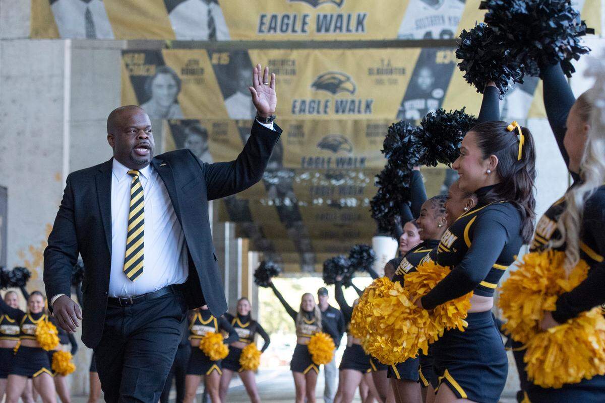 Southern Miss’ new head football coach Charles Huff walks down the Eagle Walk during a public welcome celebration for Huff at The Rock in Hattiesburg on Thursday, Dec. 12, 2024.