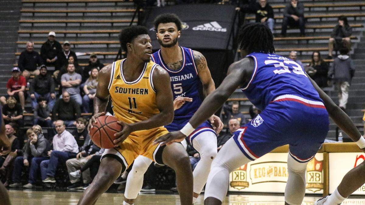 Southern Miss junior LaDavius Draine is defended by Kaleb Ledour (5) Andrew Gordon (10) of Louisiana Tech during a game in Hattiesburg on Dec. 30, 2019.