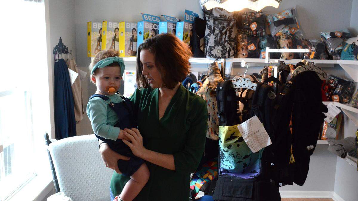 JUSTIN MITCHELL/SUN HERALDHallie Waldrep comforts daughter Isabella, 1, at her natural baby products boutique, Maternal Instinct. Waldrep also offers natural parenting education for young or low-income mothers.