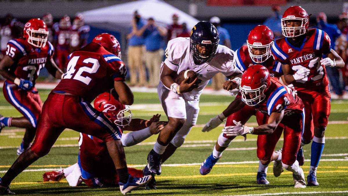 Kaden Irving, a sophomore quarterback for the Gautier Gators, busts through the Pascagoula defensive line for a touchdown in Gautier’s 43-20 victory over the Panthers on Oct. 8, 2020.