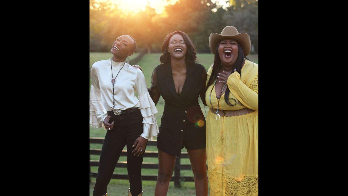 Chapel Hart members from left, Trea Swindle, Devynn Hart and Danica Hart, celebrate a new song “Glory Days,” a national tour and the debut of their Loretta Lynn tribute song at Grand Ole Opry.