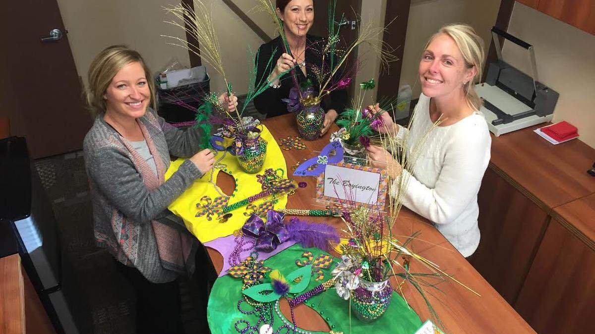 COURTESY CHRIS VIGNESKatie King, left, Liz Macmillan and Brittany Dyess, all of the Gulfport Department of Leisure Services, make decorations for the upcoming Mardi Gras Mambo for Harrison County seniors.