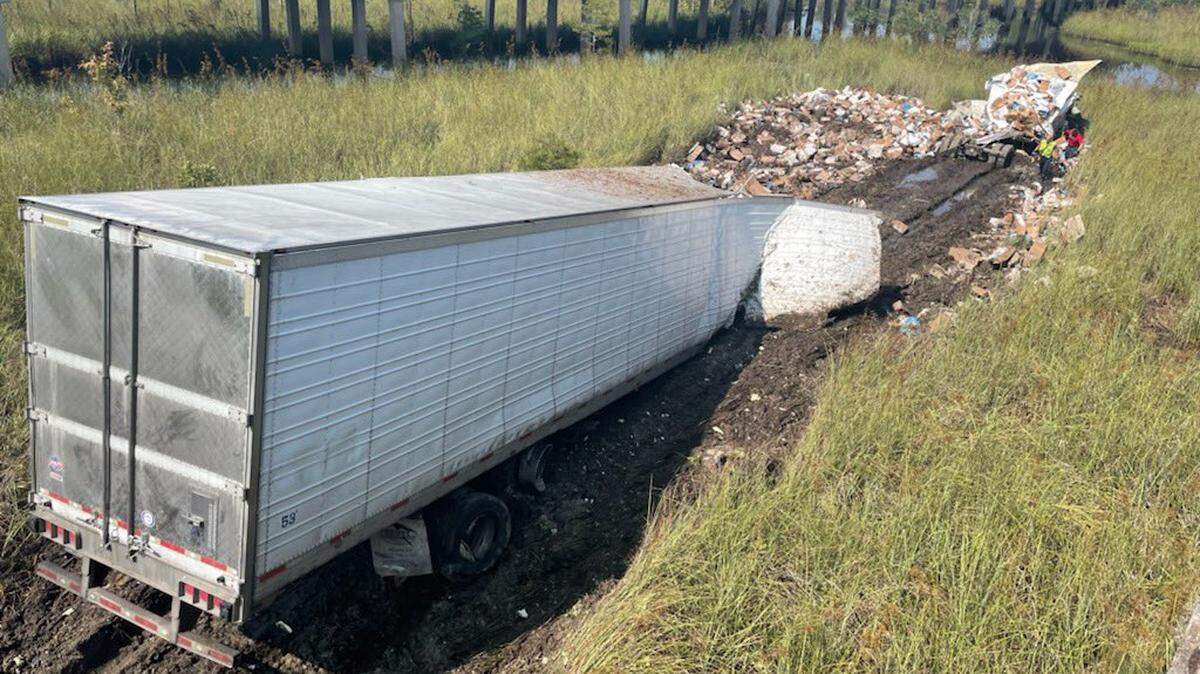 A semi-truck crashed into marshland off Interstate 10 near the Mississippi-Alabama state line, causing traffic delays.