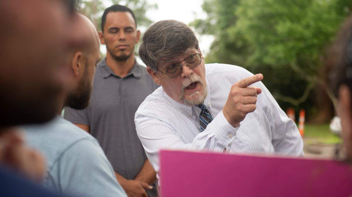 Rev. Blair Bradley, pastor for the Covenant of Peace Church in Harrison County, argues with protestors who are against banning library books outside the West Biloxi library in Biloxi where a library board meeting was being held on Monday, July 25, 2022.