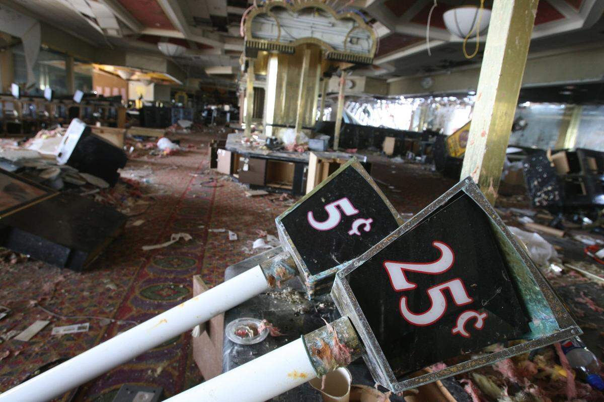 Signs advertising slot machines lie among the rubble of the Grand Casino Biloxi barge after Hurricane Katrina.