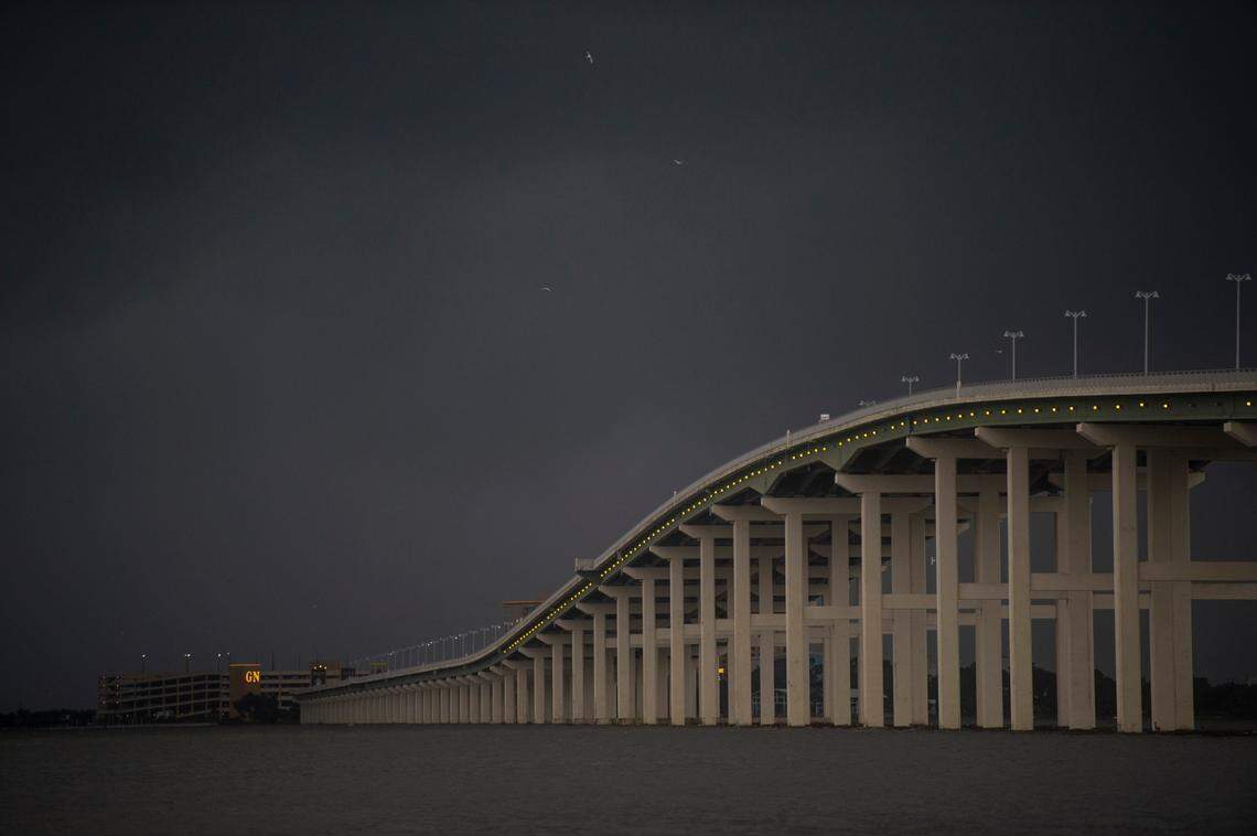 Dark clouds loom over the bridge between Biloxi and Ocean Springs as Hurricane Ida arrives on Sunday.