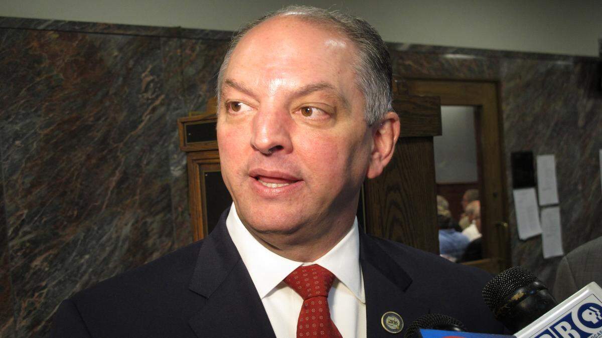 Louisiana Gov. John Bel Edwards talks with reporters about his budget cut proposal for the upcoming fiscal year after speaking to the House Appropriations Committee, Tuesday, April 12, 2016, in Baton Rouge, La. Edwards is proposing to close a $750 million budget shortfall with cuts to the TOPS free college tuition program, safety net hospitals for the poor and public schools. (AP Photo/Melinda Deslatte)
