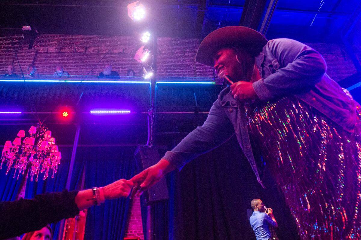 Danica Hart of Chapel Hart reaches out to a fan in the crowd during Chapel Hart’s peformance at Ground Zero Blues Club in Biloxi on Wednesday, Nov. 30, 2022.