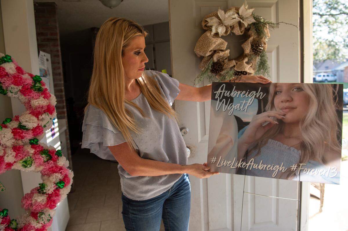 Heather Wyatt holds a yard sign she had made celebrating Aubreigh at her home in Ocean Springs on Tuesday, March 12, 2024. Wyatt has been using social media hashtags like #LiveLikeAubreigh since Aubreigh’s death to raise awareness for suicide prevention.