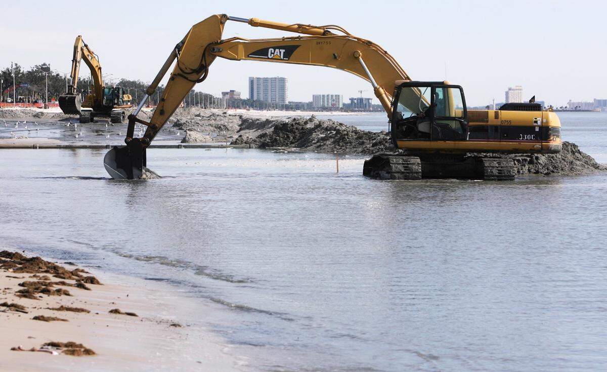In 2008, backhoes created a dam for dredged sand and water to be pumped into as employees of Enco Dredging of Gulf Shores, Ala., worked on the Harrison County beach replenishment project.