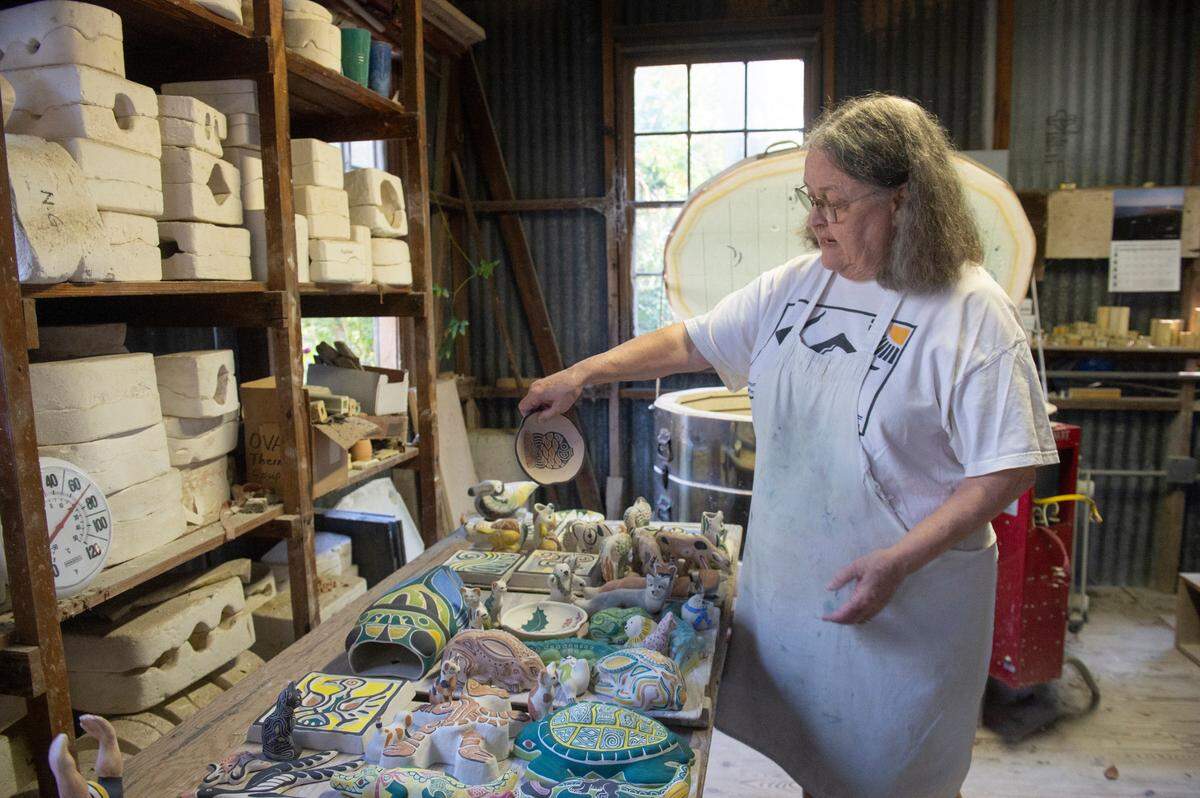 Adele Lawton, Walter Anderson’s niece, shows off pieces she’s created from original works by her father, Mac Anderson, at the Shearwater Pottery workshop in Ocean Springs. Lawton is creating tiles and other pieces that will decorate The Traveler, a new building at the Walter Anderson Museum of Art.