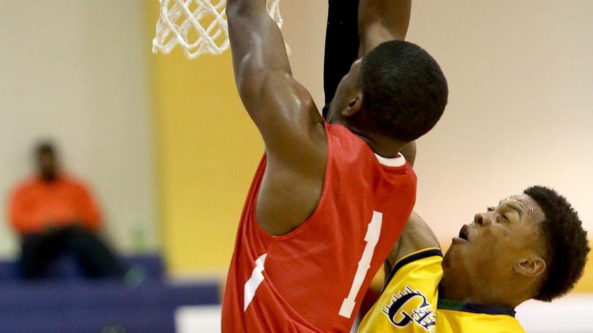 AMANDA McCOY/SUN HERALD 
 Gautier's Kelvin Robertson, right, guards Biloxi's Jordan Lewis while playing in the St. Martin Super Saturday basketball tournament on Saturday, November 7, 2015.