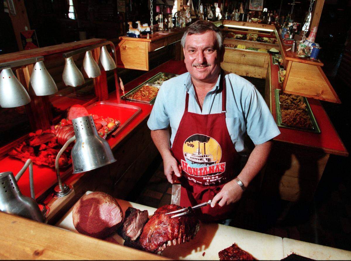 Ken Montana shows off his skills cutting ribs and ham at the buffet in his Montana’s restaurant in Gulfport in this 1999 file photo.
