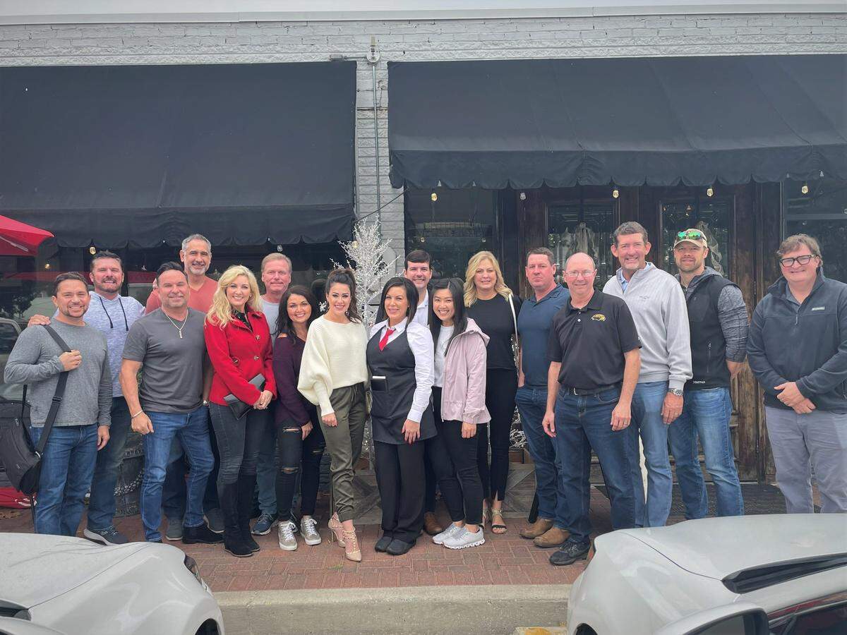 Ashley Sadler, in her server uniform at the center of the photo, is surrounded by a group of people who each tipped her $100 Tuesday at Phoenicia Gourmet Restaurant in Ocean Springs. “I feel so blessed,” she said.