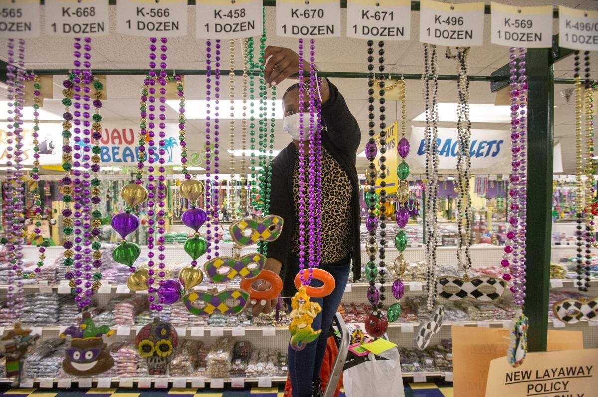 Retail manager Latoya Newman organizes bead displays at Beads By The Dozen in Elmwood on Friday, Feb. 12, 2021.