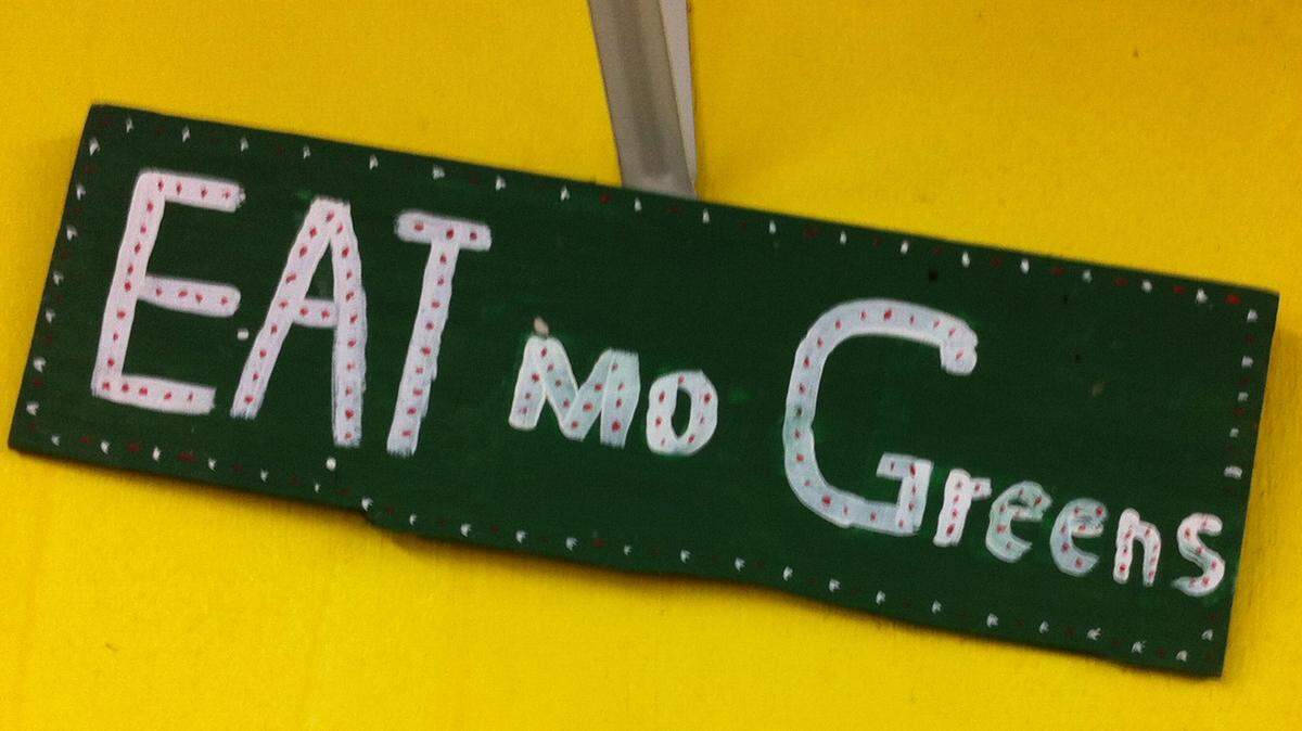 NATE THURMAN/SUN HERALD 
 A folk art sign encourages customers to eat greens at Four Seasons Produce in Moss Point on Friday, Nov. 6, 2015.