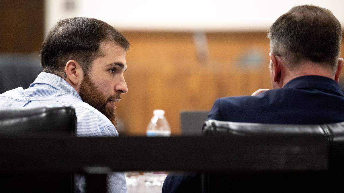 Logan D’Elena, left, speaks with his attorney, John Weber, right, during a testimony hearing at Harrison County Circuit Court on Tuesday, Nov. 18, 2025.