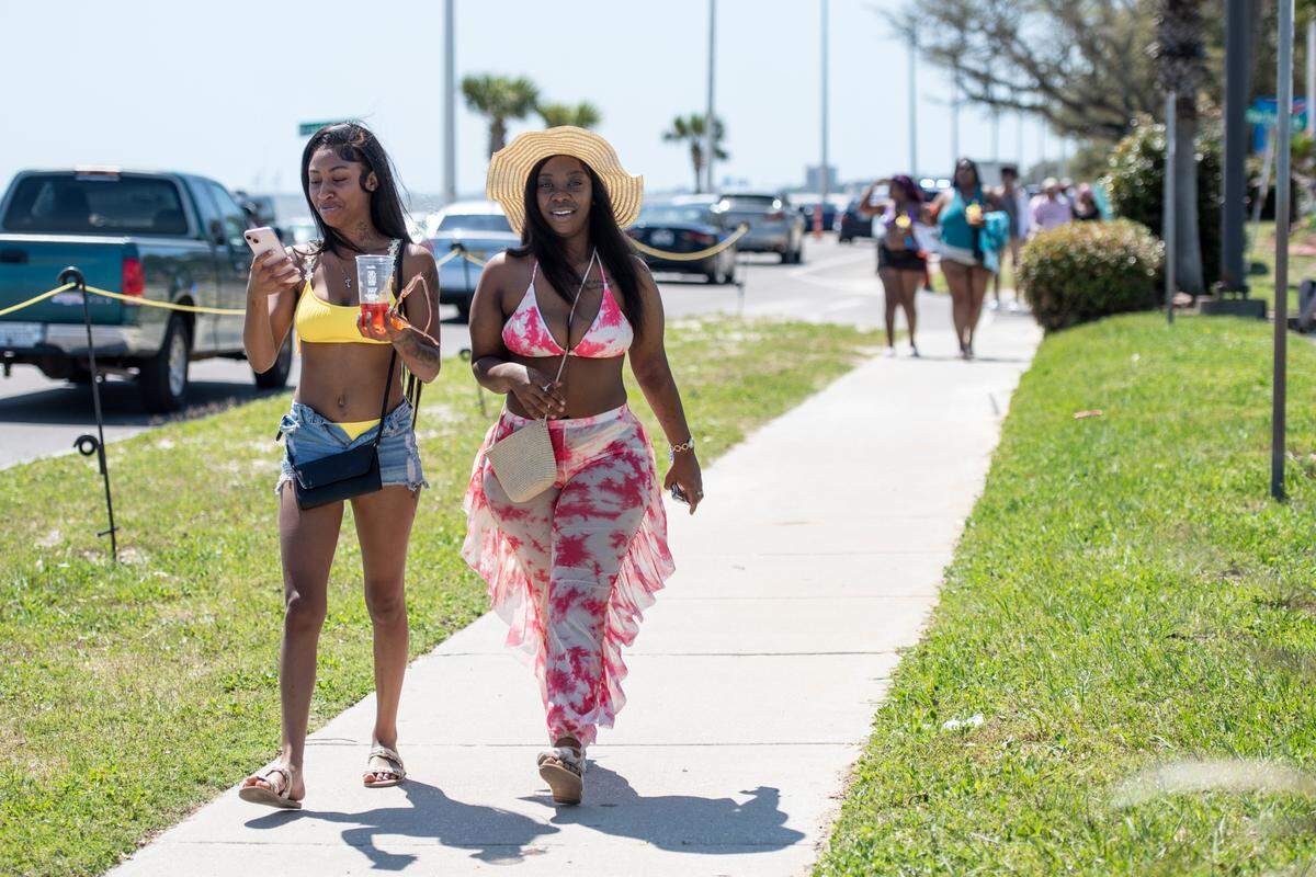 Spring breakers walk along Highway 90 during Black Spring Break in Biloxi on Saturday, April 13, 2024