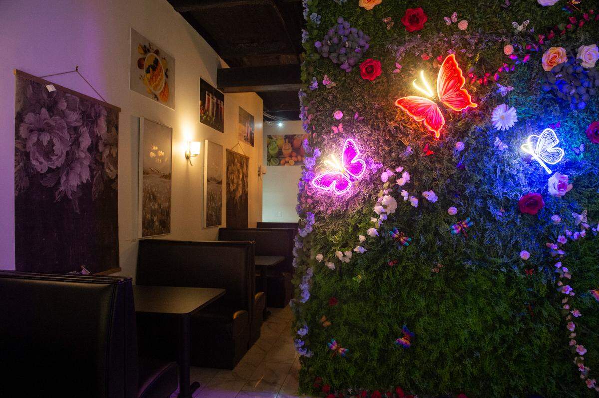 The dining area and a selfie walk are colorful spots at Zaki’s Cafe in Gulfport.