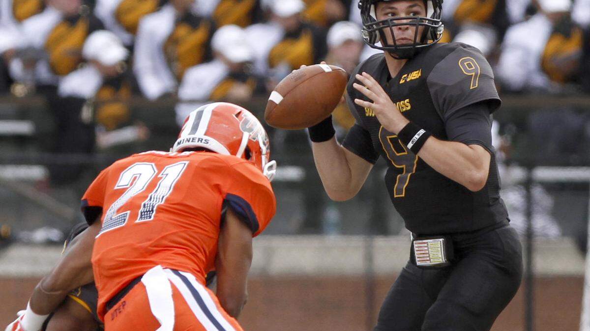 TIM ISBELL/SUN HERALDSouthern Miss quarterback Nick Mullens looks for an open receiver as UTEP's Dashone Smith applies pressure, Saturday, Oct. 31, 2015. 