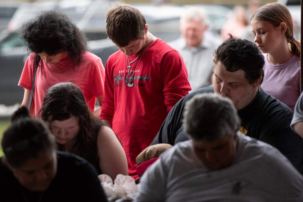 Community members and family pray during a candlelight vigil in remembrance of Gracelynn Vick at Saucier Park on Tuesday, April 22, 2025.