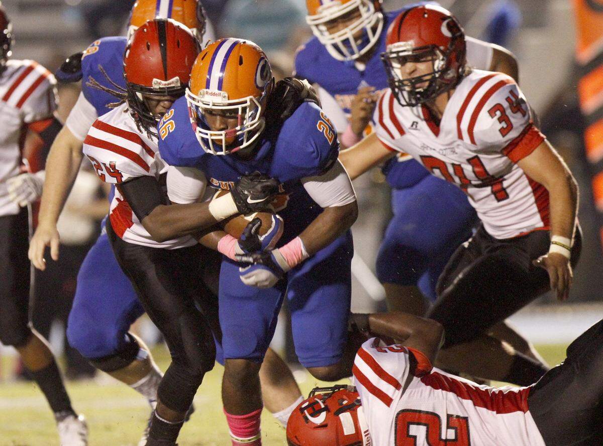 TIM ISBELL/SUN HERALD  A host of Harrison Central defenders try to bring down Gulfport running back Deon Cole, Oct. 16, 2015.