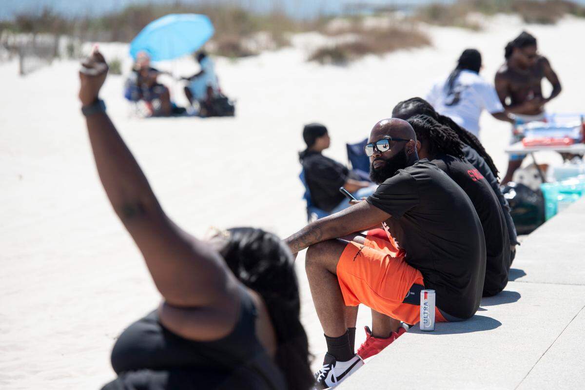 Spring breakers along Biloxi Beach during Black Spring Break on Saturday, April 12, 2025.