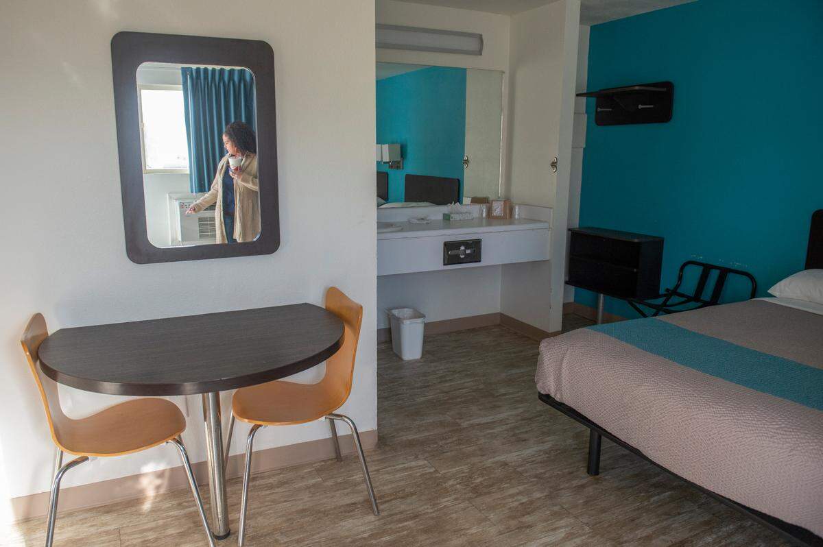 Motel 6 manager Tiffany Scheid is reflected in a mirror in the motel room that was rented by Amy Brogdon Anderson the night Anderson shot and killed Bay St. Louis officers Sgt. Steven Robin and Branden Estorffe.