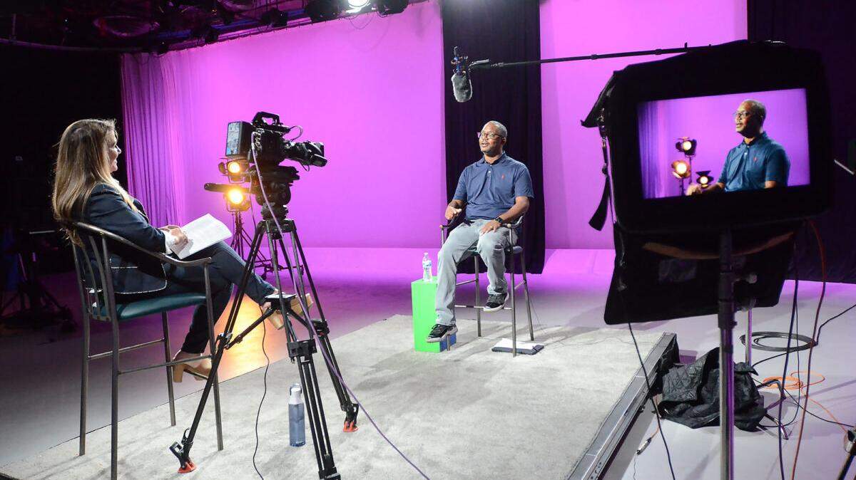 Mississippi Public Broadcasting’s Chief Operations Officer Anna Neel (left) and Chief Content Officer Taiwo Gaynor chat on set about Gaynor’s upcoming Medgar Evers documentary at MPB headquarters, Friday, Aug. 1, 2025, in Jackson.  (Vickie D. King/Mississippi Today
)