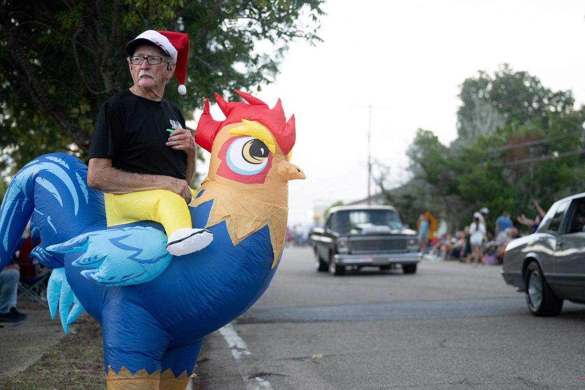 Paul Clifton watches vintage cars pass by as he wears a chicken outfit during the Long Beach Cruisin’ The Coast Parade on Monday. Cruisin’ The Coast continues Wednesday with events in Biloxi, Waveland and Diamondhead.