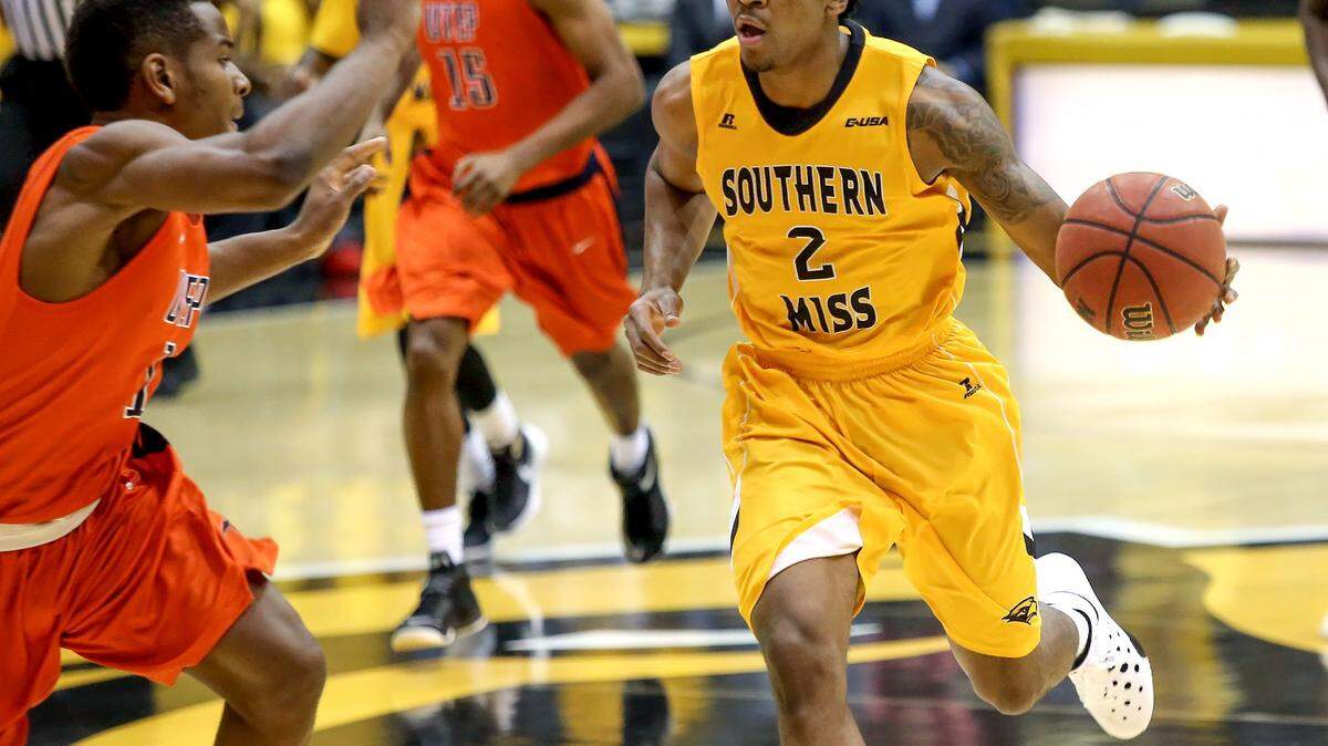 AMANDA McCOY/SUN HERALD 
 Southern Miss guard Kourtlin Jackson dribbles the ball down the court while UTEP guard Dominic Artis defends on Thursday, January 28, 2016, in Hattiesburg.