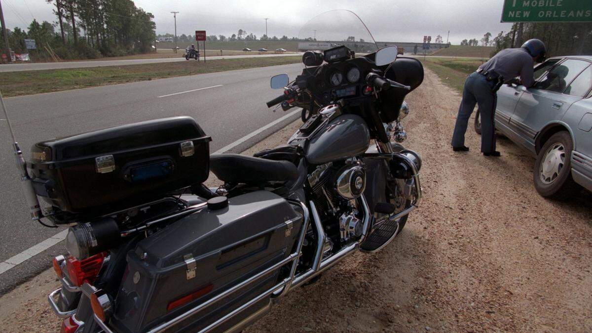 SUN HERALD FILE 
 A Mississippi Highway Patrol officer cites a speeding motorist on Miss. 603 in Hancock County. Mississippi is on the lower end of average insurance rate increases for motorists caught driving 31 mph or more over the speed limit, but that could soon change because of the state's high accident rate per insured driver.