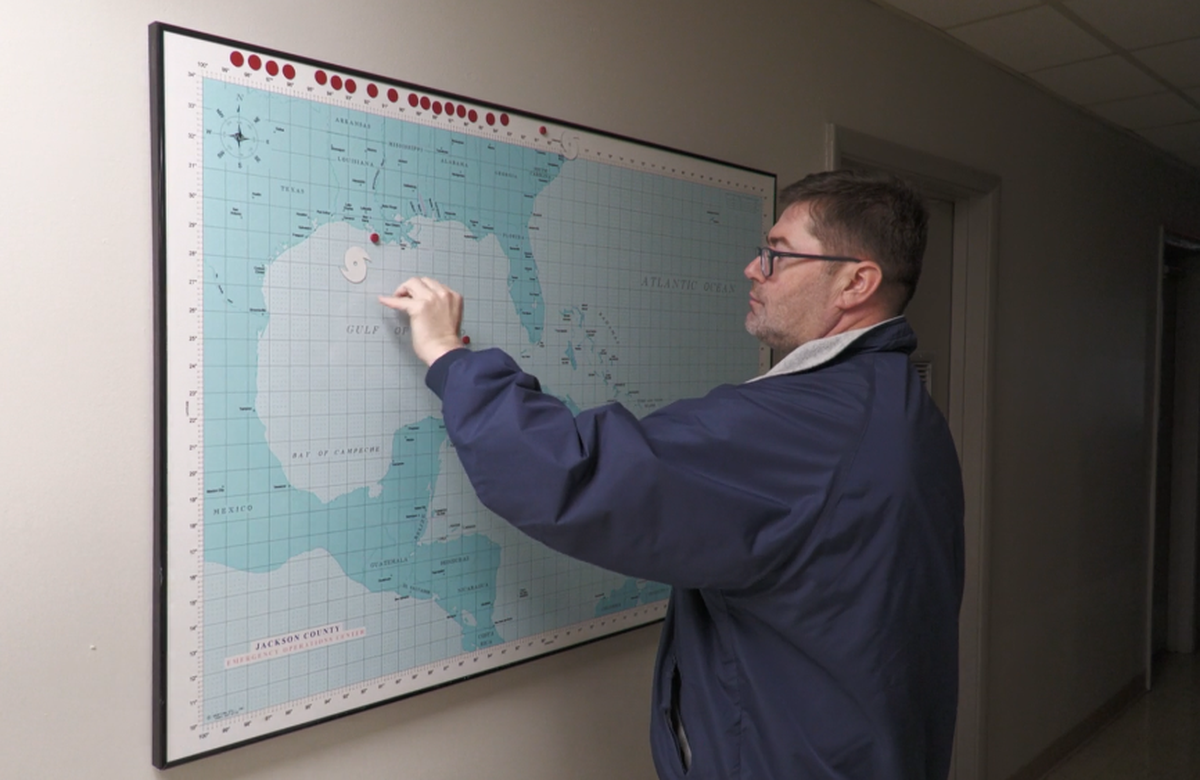 Chad Brownlow, Emergency Management Coordinator for Jackson County, describes how people predicted the path of hurricanes by using the storm’s last known location, prior to any digital mapping technologies.