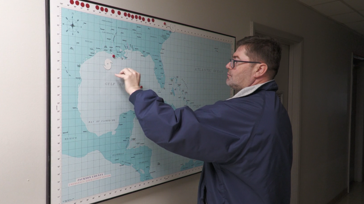 Chad Brownlow, Emergency Management Coordinator for Jackson County, describes how people predicted the path of hurricanes by using the storm’s last known location, prior to any digital mapping technologies.