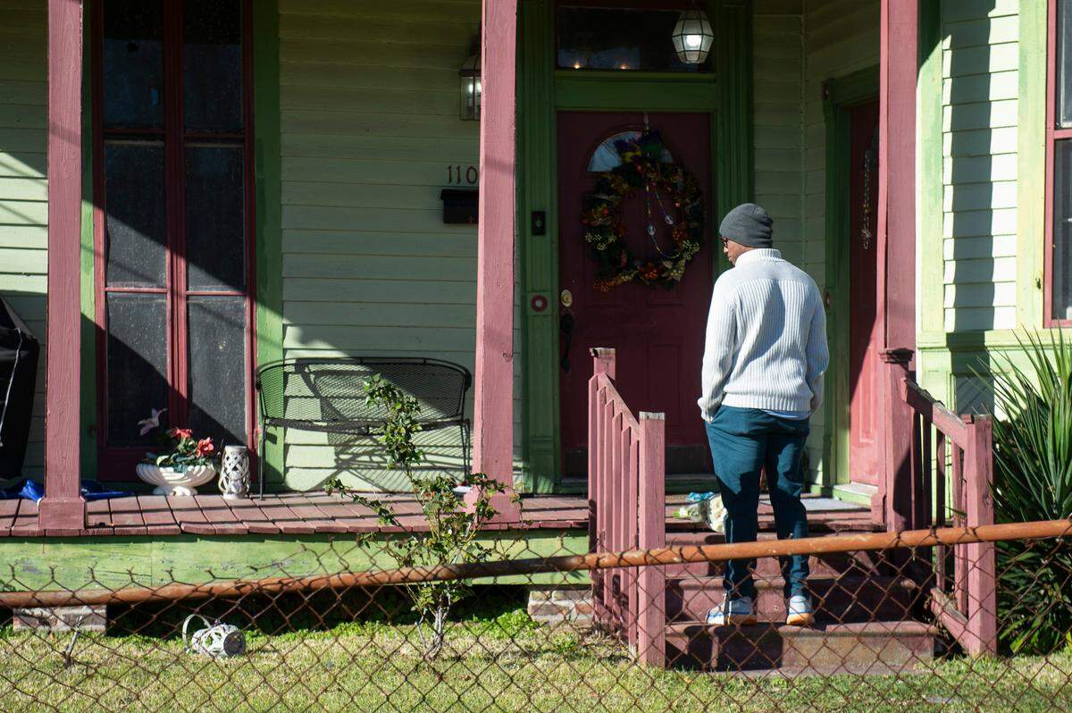 Damian Robinson, Payne’s son, stands on the front porch of the home of Harold Payne, 85, and Jittaun Payne, 71, on Thursday, March 6, 2025. The Paynes were killed on Wednesday when their son Darold Sim Payne, 39, allegedly beat them to death with a cinderblock.