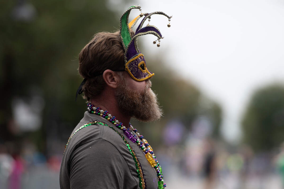 A man wears a masquerade mask during The Ocean Springs Elks Carnival Parade in downtown Ocean Springs on Saturday, Jan. 27, 2024.