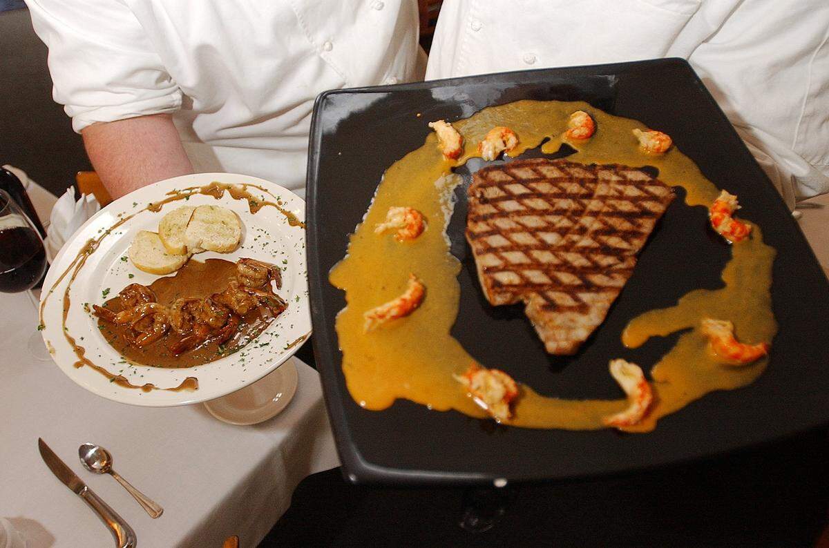 Southern Style BBQ Shrimp, left, and grilled rare Yellowfin tuna were among the entrees at Tigre’s in Pass Christian.