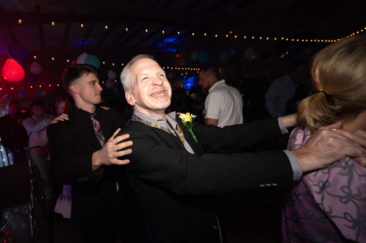 Guests of honor and volunteers dance together during Night to Shine at Woolmarket Baptist Church on Friday, Feb. 13, 2026.