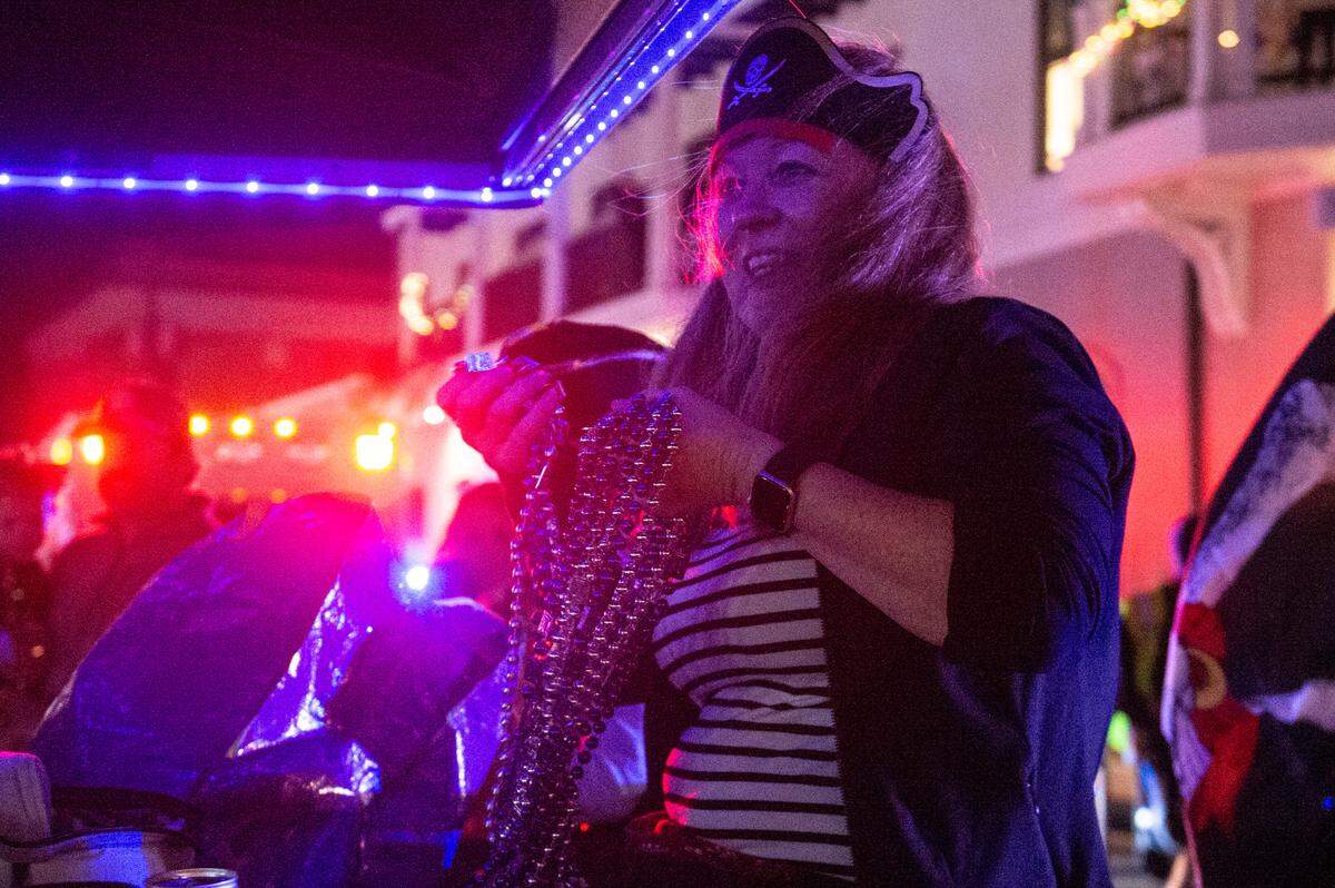 A member of Mystic Krewe of the Seahorse throws beads during the krewe’s Lundi Gras parade in Bay St. Louis on Monday, March 3, 2025.