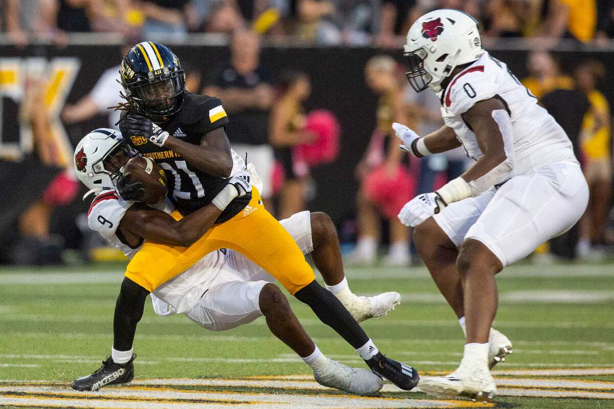Southern Miss Golden Eagles wide receiver Tiaquelin Mims (21) gets tackled by Arkansas State Red Wolves Trevian Thomas (9) and John Mincey (0) during a game at M.M. Roberts Stadium in Hattiesburg on Saturday, Oct. 15, 2022.