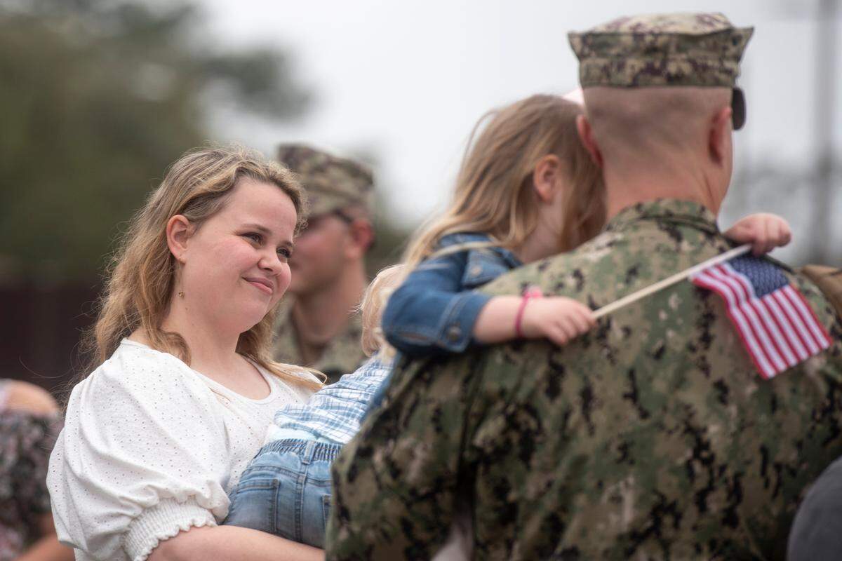 Members of Naval Mobile Construction Battalion 133 reunite with their families after returning from deployment at a homecoming event at the Naval Construction Battalion Center in Gulfport on Tuesday, March 5, 2024.
