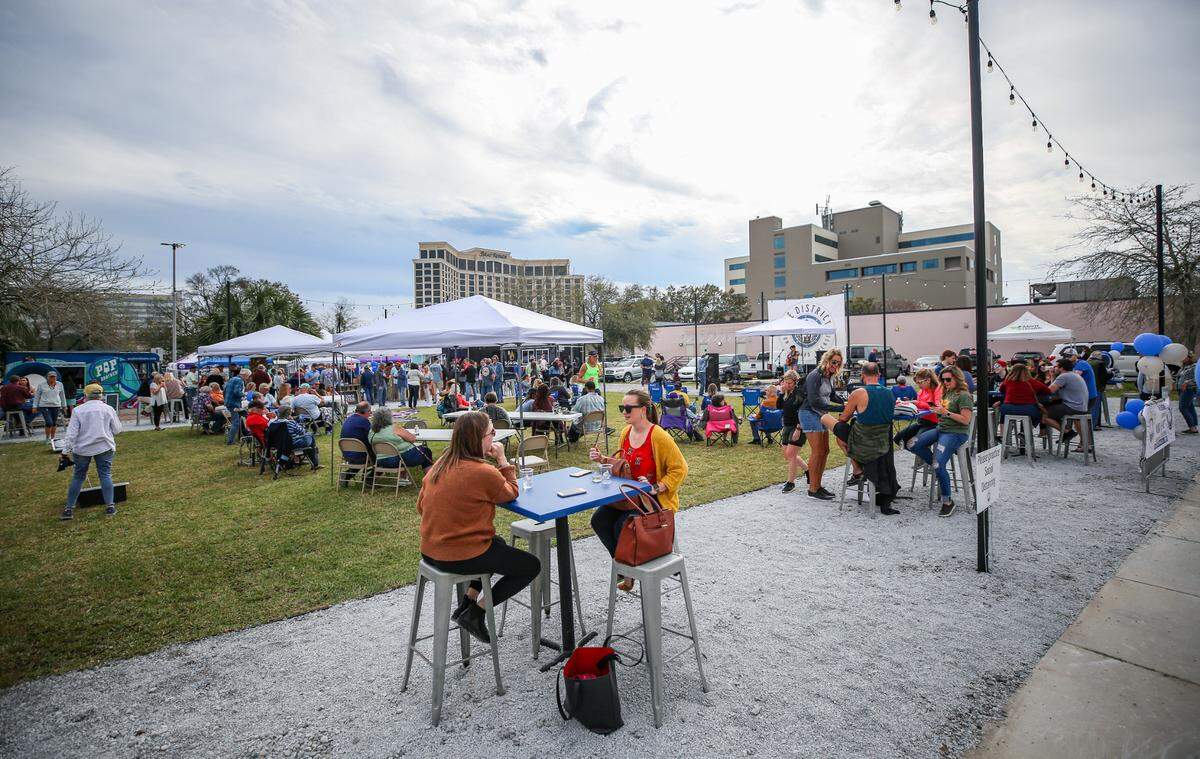 People filled in seating across the District Green space to listen to music and enjoy food from local food trucks as a block party kicked off the space’s first official event downtown on Howard Avenue in Biloxi.