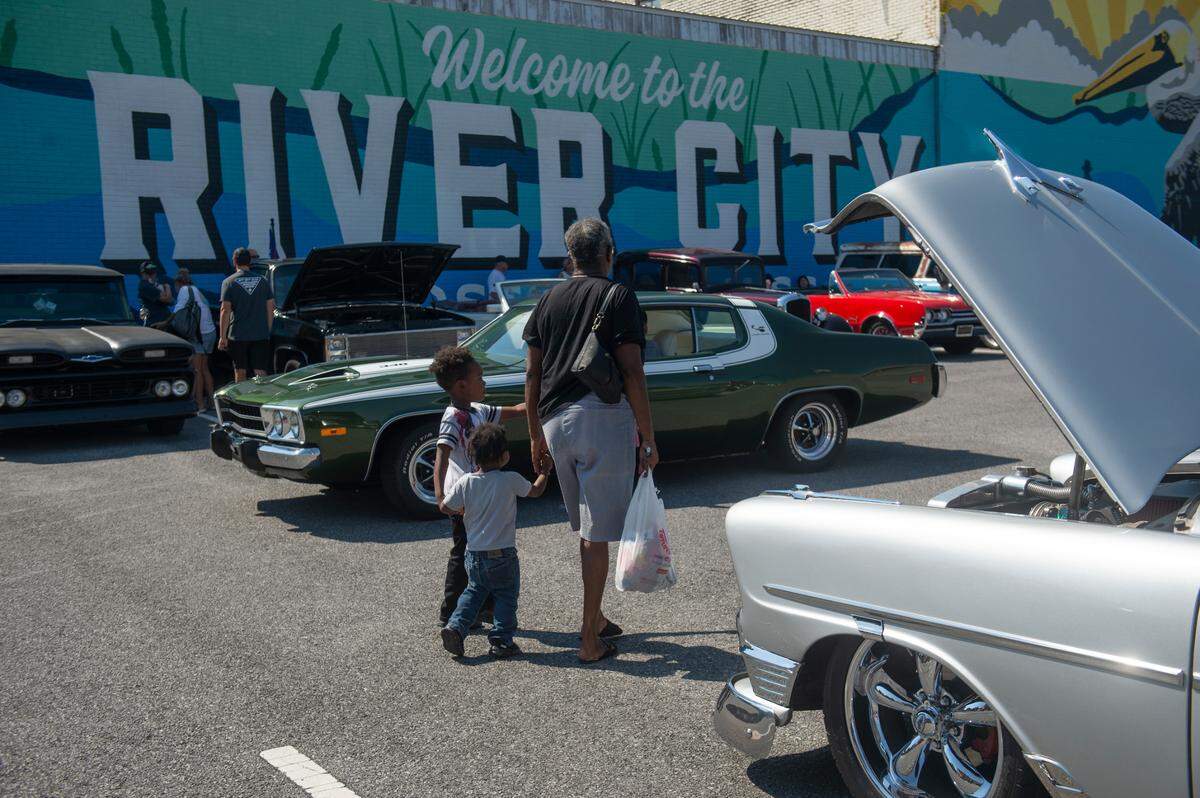 Spectators walk around downtown Moss Point during Cruisin’ The River City, a Cruisin’ The Coast event on Tuesday, Oct. 8, 2024.